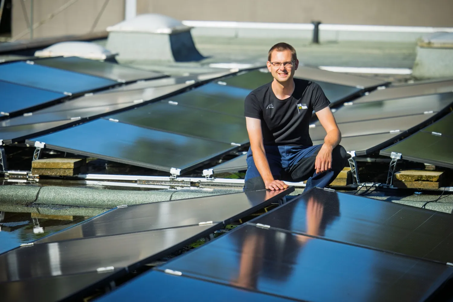 Michael on the boathouse roof with solar modules