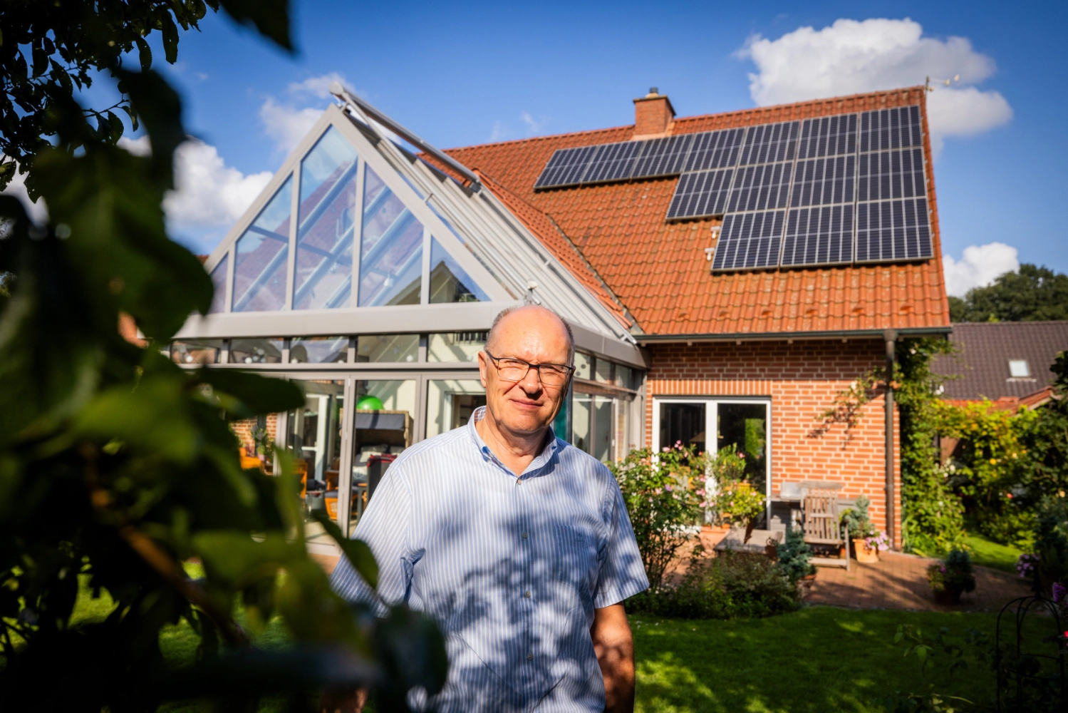 Andreas vor Haus mit PV-Anlage