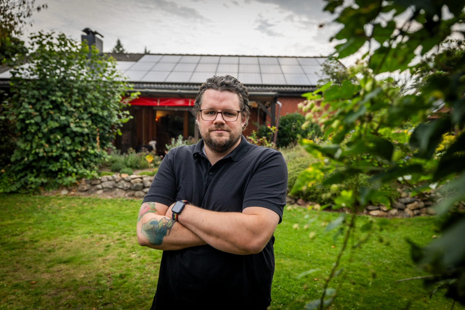 Bastian in front of his house